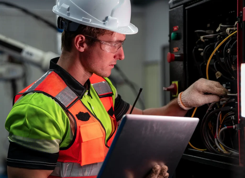 Electrical engineer using a laptop for diagnostics